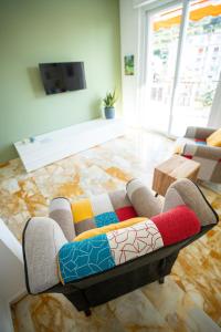 a living room with a couch with a colorful rug at MICKY HOUSE in Sanremo