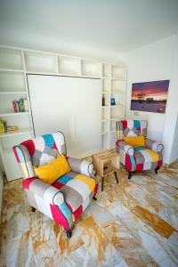 two chairs and a couch in a living room at MICKY HOUSE in Sanremo