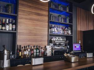 a bar with a lot of bottles of alcohol at Hotel NIKS in Sevlievo