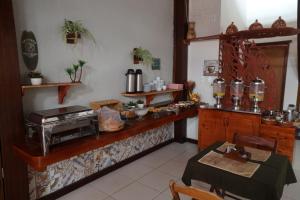 a kitchen with a counter and a table and a table at Pousada Vila Tutóia in Tutóia