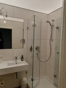 a bathroom with a shower and a sink at Lindner's Hotel in Bellheim