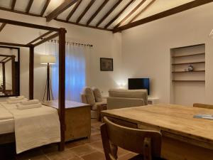 法塔加Casa Rural Palomar - Men Only的带桌椅和电视的客厅