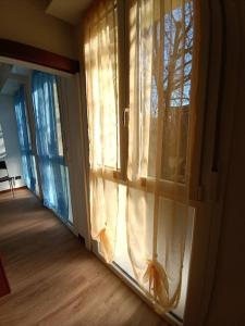 a room with a window with curtains on it at Residenza Bologna 04 marzo in Bologna