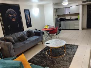a living room with a couch and a table at Rgr ONE BEDROOM APARTMENTS in Lagos