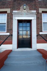 a door to a brick building with a stairs leading to it at The Jazz Suite B1 in Hartford