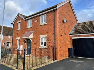 a brick building with a gate and a garage at Stunning Large Detached Gloucester, 4 beds, 3 bedroom, 2 bathroom property, Nr Chelt, The Docks and Quays sleeps 6 in Gloucester