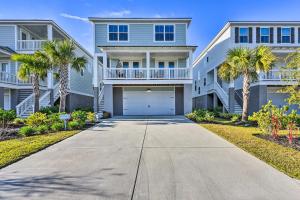a house with palm trees in front of a driveway at 3 Decks and Water Views Breezy Home in Hilton Head in Hilton Head Island