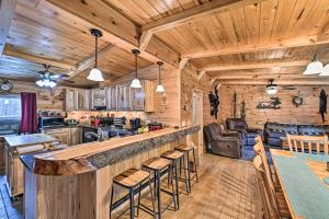 a kitchen and living room with a bar in a cabin at Otego Home with Hot Tub Near All Star Village! in Oneonta