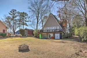 a house with a large yard in front of it at Waterfront Chapin Home with Private Dock! in Lake Murray Shores
