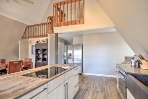 a large kitchen with a counter top and a staircase at Waterfront Chapin Home with Private Dock! in Lake Murray Shores