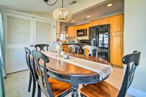 a kitchen and dining room with a wooden table and chairs at Waterfront Beach Haven West Home with Boat Dock in Manahawkin