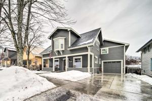 a gray house with a garage in the snow at Charming Kellogg Home Near Outdoor Activities in Kellogg