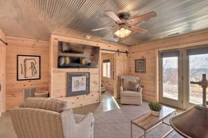 a living room with a ceiling fan and chairs at Mountain Home Cabin Rental with Fire Pit! in Mountain Home
