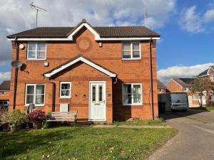 a brick house with a bench in front of it at House - 10min to City Centre - Sleeps 4 - Parking in Birmingham