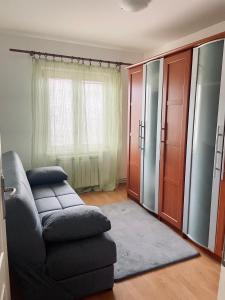 a living room with a couch and a window at Apartman Bloom in Novi Grad