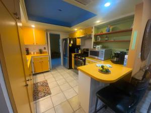 a kitchen with yellow cabinets and a yellow counter top at Casa Limon with HEATED POOL in Sarasota