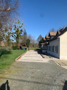 a shadow of a person standing next to a house at Saint Martin in Roézé-sur-Sarthe