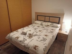 a bedroom with a bed with butterflies on it at Nice Place Santa Pola in Santa Pola