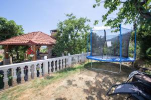 a blue swing in a yard next to a fence at Studio apartment in Ika with balcony, air conditioning, WiFi, washing machine 5025-3 in Ika