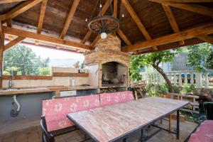 an outdoor kitchen with a wooden table and a dining room at Studio apartment in Ika with balcony, air conditioning, WiFi, washing machine 5025-3 in Ika