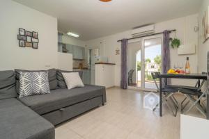 a living room with a gray couch and a table at Apartamento SARAY in Son Carrio