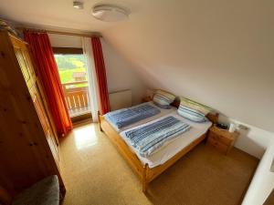 a small bedroom with a bed and a window at Ferienwohnung Käppelehof in Schramberg