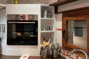 a kitchen with a counter with a stove and a counter top at Classical corner town house in historical centre in Altea