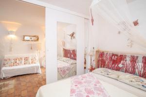 a bedroom with two beds and a mirror at La Casa delle Conchiglie in Capo Coda Cavallo +41 photos