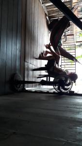 a person sitting on a motorcycle in a building at Posada El Acuario in Bahía Solano