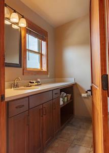 a bathroom with a sink and a mirror at Yellowstone Valley Lodge, Ascend Hotel Collection in Pray