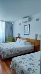 two beds in a hotel room with blue walls at Varandas da Ria in Costa Nova