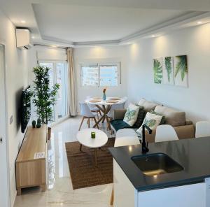 Apartamento Ronda III في فوينخيرولا: غرفة معيشة مع أريكة وطاولة