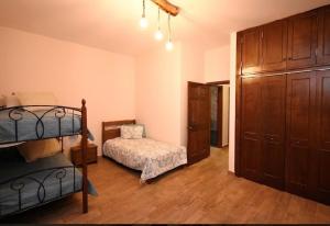 a room with a bunk bed and a bedroom with a bunk bed at Aktea coastal village home in Kalymnos