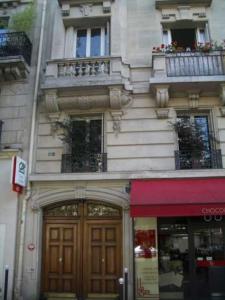 a building with two doors and a red awning at Gobelins in Paris