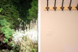 a white door with a plant next to it at Bath City Skyline Spacious 3 Bed House for family in Bath