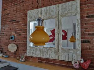 a large yellow vase hanging from a brick wall at Apart luminoso, céntrico y a 2 min de la playa in Sant Feliu de Guixols