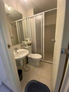 a bathroom with a toilet and a sink at Azure BEACHfront view Aesthetic Minimalist unit in Manila