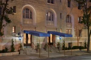 a building with two blue signs in front of it at Hotel Ulysses, a Member of Design Hotels in Baltimore