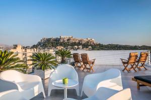 a balcony with chairs and a view of the city at Acropolis Panorama View Penthouse with Private Terraces A Contemporary Parthenon in Athens