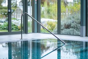 a swimming pool in a building with a swimming pool at Woolley Grange - A Luxury Family Hotel in Bradford on Avon
