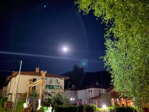 a full moon rising over a building at night at Eco Rai Rekata in Apriltsi