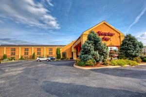 a hotel with a sign on the front of a building at Hampton Inn Morristown in Morristown