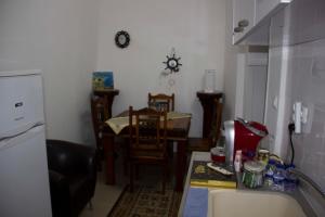 a kitchen with a counter and a table and chairs at Shamokh House in Acre