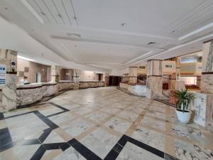 a large room with a lobby with a tile floor at Helya Beach Resort in Monastir