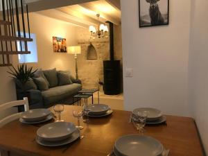 a dining room table with plates and wine glasses at Cottage de charme proche de Paris in Fontenay-en-Parisis