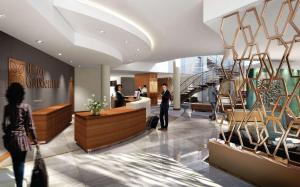 a lobby of a hotel with people standing in the lobby at Hilton Garden Inn Society Business Park in Lusaka