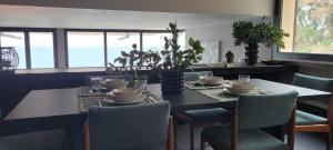 a dining room with a table with chairs and a tableablish at La maison sur mer in Torri del Benaco