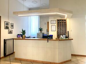 a lobby with a reception counter in a building at Hotel Serena in Rieti