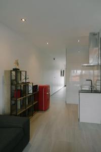 a living room with a red suitcase in a room at ONE LODGE Pattaya in Pattaya Central