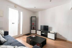 a living room with a couch and a tv at Home Lisbon 2 in Lisbon